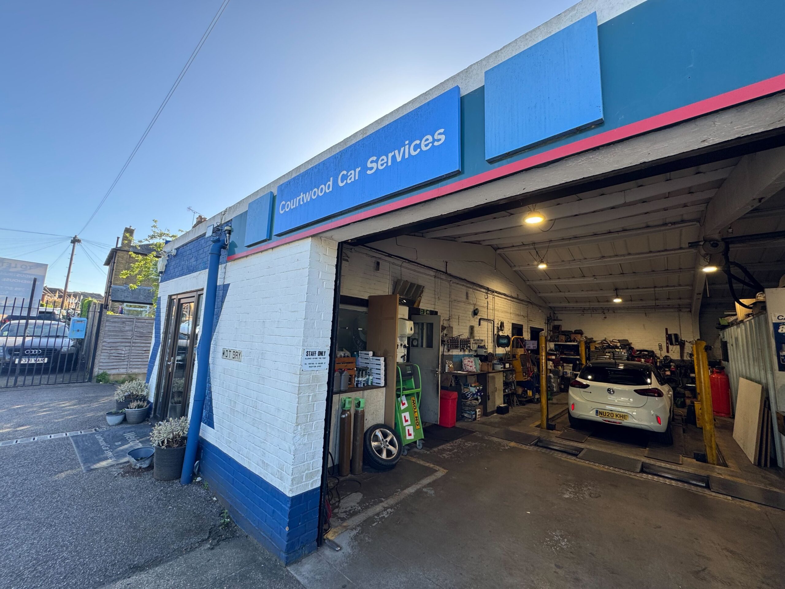 Front of the Courtwood Car Services garage on Lancaster Road, Uxbridge, in daylight