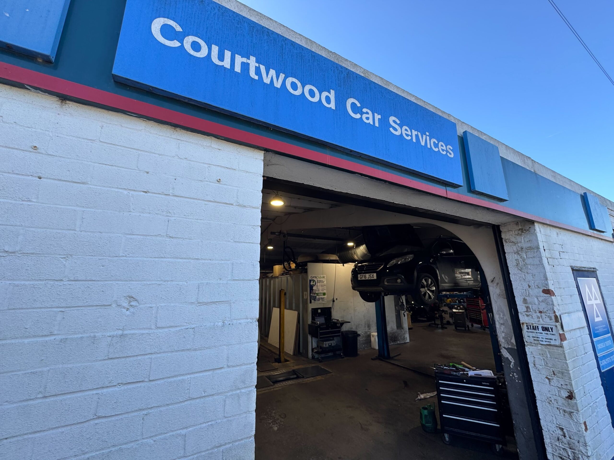 Courtwood Car Services signage close up at the Uxbridge garage entrance