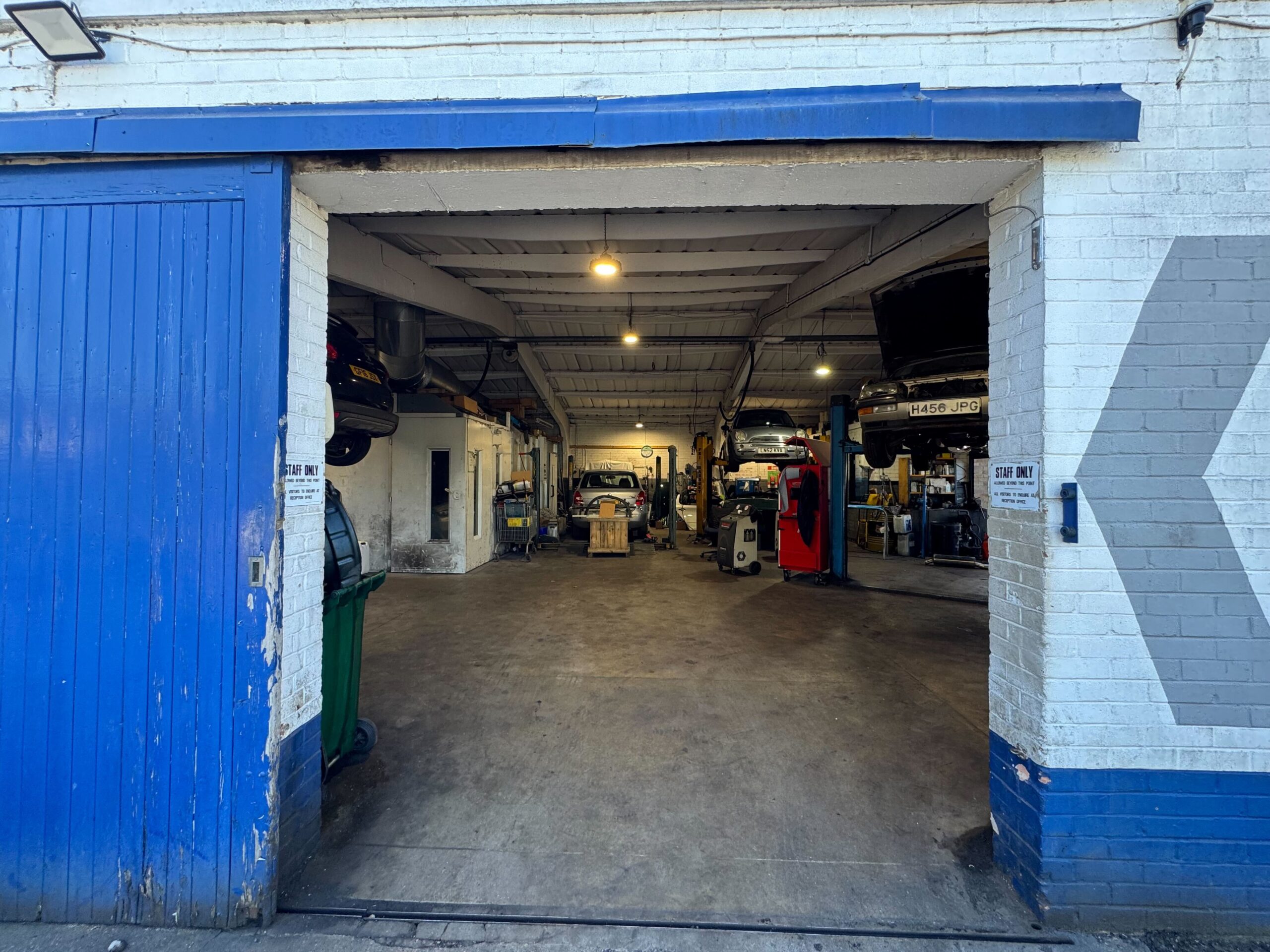 Renault Trafic courier van entering the main workshop bay for MOT testing near Heathrow