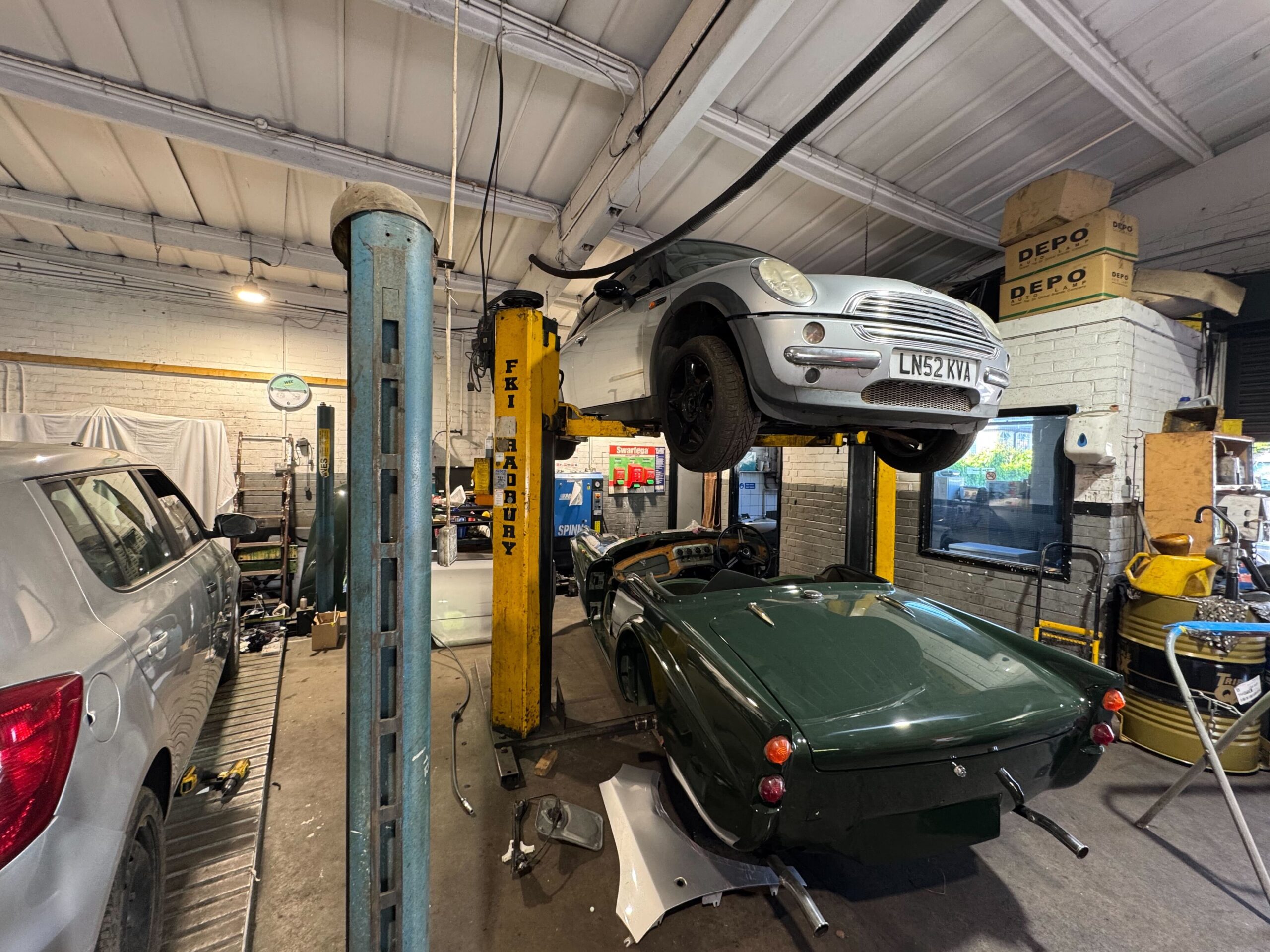 Mini Cooper raised on a car lift for Class 4 MOT inspection in Uxbridge