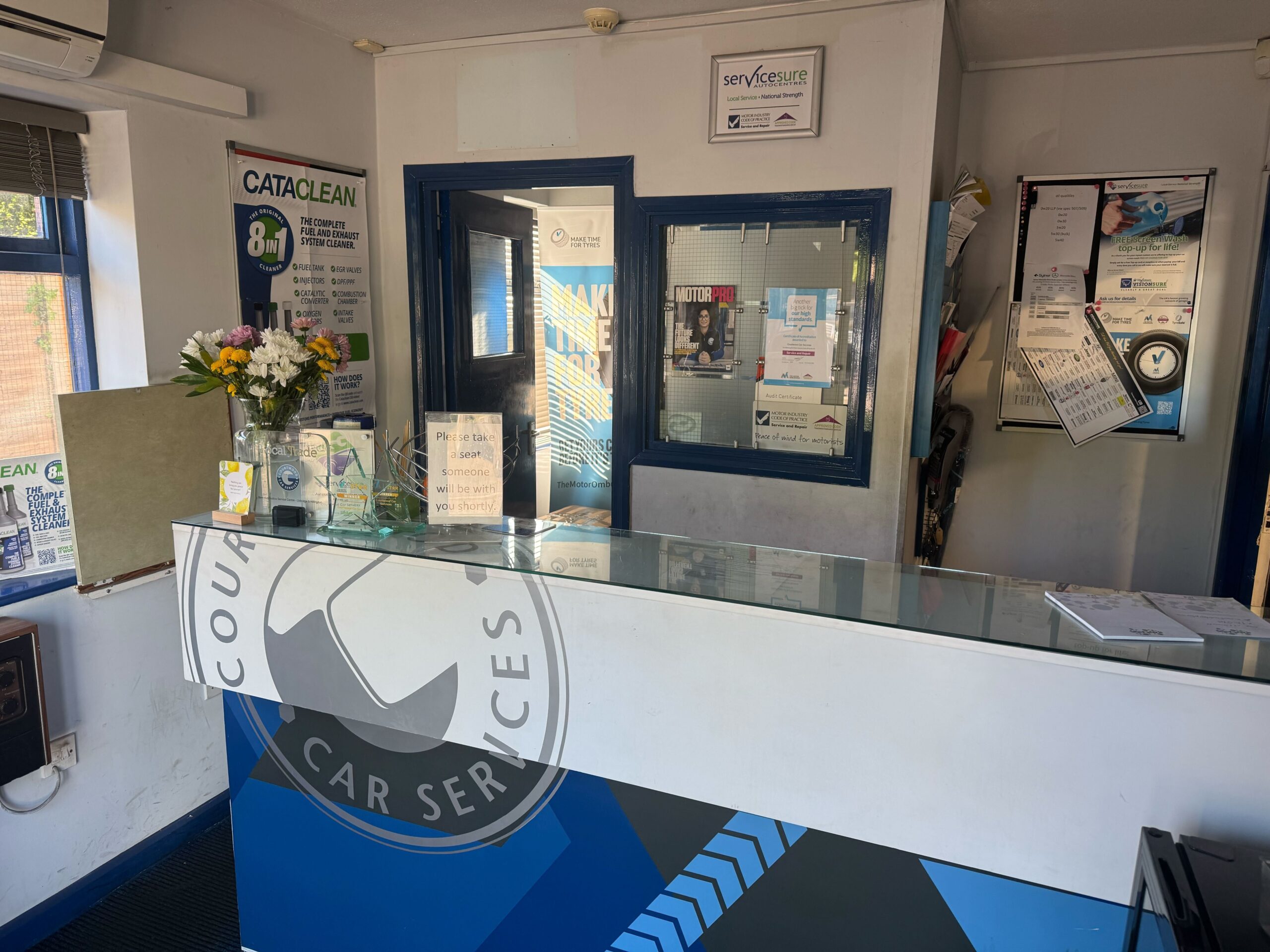 Customer reception desk at Courtwood Car Services Uxbridge during MOT drop off