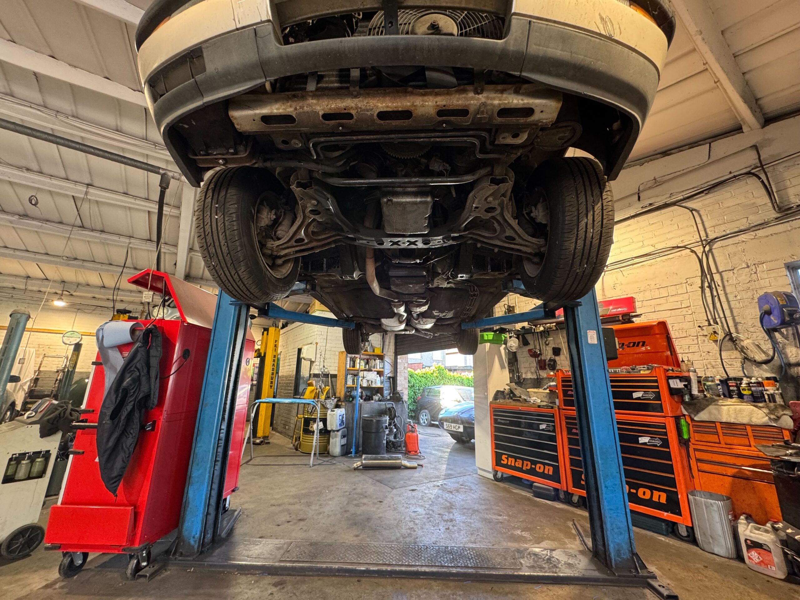 Class 4 car MOT underbody inspection on a hydraulic lift at Courtwood Car Services Uxbridge